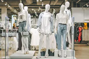 Dummy Prints: Mannequins in denim and white clothes in clothing store in shopping mall