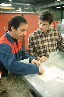 Explaining Prints: Manual worker and apprentice at work table