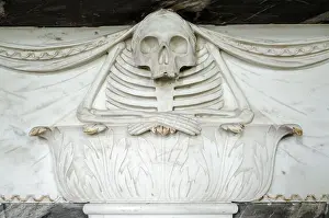 Frightening Prints: A marble carving from the 18th century showing a skeleton resting his folded arms on a plinth decorated with acanthus