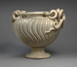 Sculptural Prints: The marble vase has strigilated decoration and snake-shaped handles