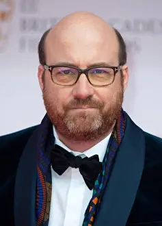 Mid Length Prints: March 13th, 2022, London, UK. Patrice Vermette arriving at the EE British Academy Film Awards