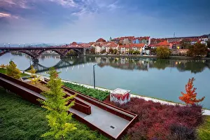 Maribor, Slovenia. Cityscape image of Maribor, Slovenia during autumn twilight with reflection of the city in Drava River. Note to editor