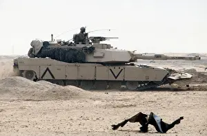 Plow Prints: A Marine Corps M-1A1 Abrams main battle tank equipped with a mine-clearing plow passes through an abandoned Iraqi
