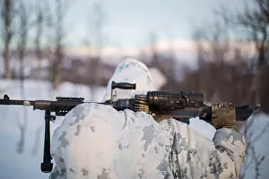 Federal Employee Prints: Marine with Marine Rotational Force-Europe moves into position before conducting a mountainous assault on enemy