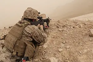 Camo Prints: US Marines with 1st Battalion, 8th Marine Regiment return fire from covered positions from enemy machine guns