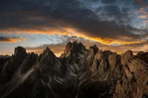 Marmarole mountain group with Cimon del Froppa against the backdrop of incredible orange sunset sky, Dolomites, Italy. Landscape photography