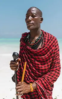 Tanzania Prints: Masai portrait posing stand up at beach