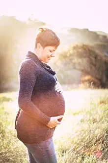 Kissing Prints: Maternity photo shoot, a pregnant mother looking at her pregnant stomach