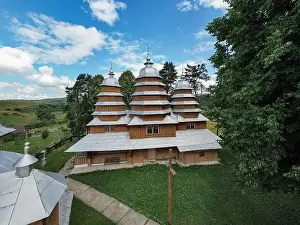 Carpathian Prints: Matkiv, Ukraine - July 21, 2021: Aerial view on ancient wooden Church of Synaxis of the Holy Mother of God in Matkiv