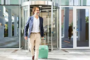 Facial Hair Prints: A mature businessman confidently exits a modern glass building