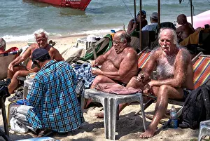 Mature male tourist with extensive body hair covering and hairy chest, sunbathing on Pattaya beach Thailand