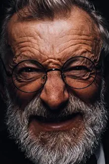 Homeless Prints: Mature man with angry grimace on face revealing in screwed-up eyes