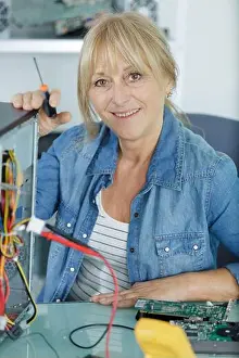 Mature Prints: a mature technician examining pc