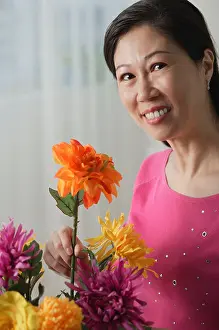 Only Women Prints: Mature woman holding flowers, smiling at camera, portrait