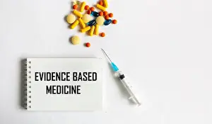 Evidence Prints: Medical concept. Text EVIDENCED PRACTICE on a notepad with vaccine and pills on a white background
