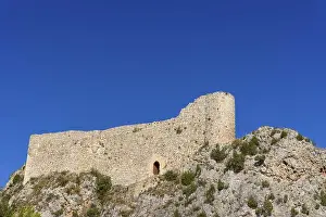 Tourist Spot Prints: Medieval castle on top of hill against blue sky. Castle of Los Rojas In Pozas de la Sal