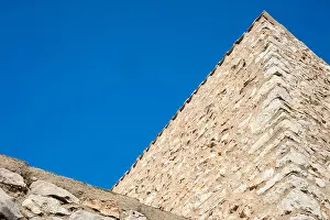 Roofing Prints: Detail of mediterranean country house made of stone on a sunny day in blue background in Catalonia