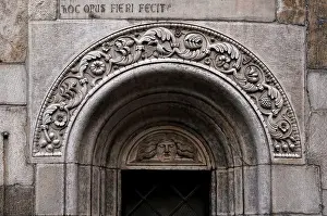 East End Prints: Medusa face with long hair stares from lunette over central apse window of Romanesque cathedral in Piazza Grande