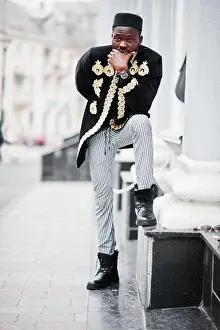 Nigeria Prints: Mega stylish african man in traditional jacket pose. Fashionable black guy in hat