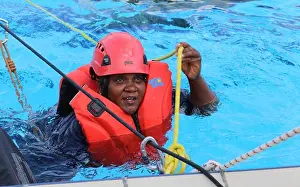 A member of the VKC swims across the simulated swift water to bring assistance to an injured patient