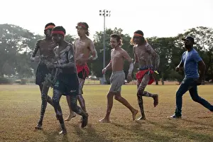 Talisman Prints: Members of the Dagoman Tribe perform a traditional dance with an Airman assigned to the 353rd Special Operations Wing