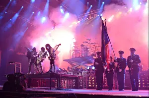 Eugene Prints: Members of the Oregon Army National Guard display the American flag on stage while the band KISS performs the National