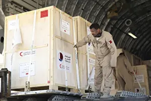 Air Traffic Prints: Members of the Qatari Air Force unload humanitarian aid supplies from a transport aircraft at Damascus International