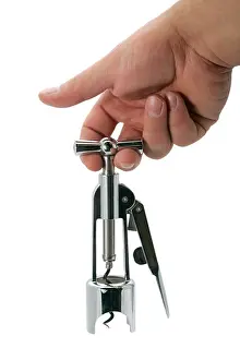 Tasting Prints: men hand holding corkscrew open bottle