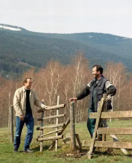 Communicating Prints: Two men talking over fence and gate