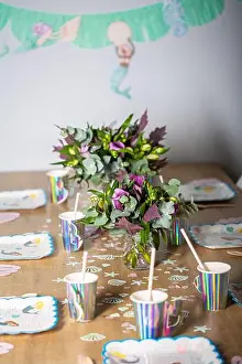 Crockery Prints: Many mermaid decoration on a birthday party wooden table with rainbow shiny drinking glasses with straw