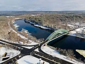 Merrimack River and Tyngsborough Bridge aerial view in winter in town center of Tyngsborough, Massachusetts MA, USA