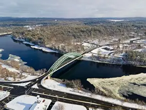 Merrimack River and Tyngsborough Bridge aerial view in winter in town center of Tyngsborough, Massachusetts MA, USA