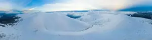 Mountain White Prints: Mesmerizing mountain panorama of hills cliffs covered with snow on a cloudy winter day