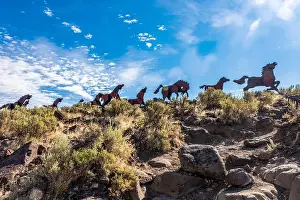 In A Row Prints: Metal art depicting wild horses running across a ridge atop the Wild Horse Monument near the town of Vantage in Eastern