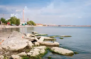 Warming Prints: Metallurgical works with smoke with dwelling houses and sea on front. Mariupol, Ukraine