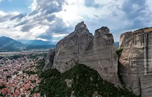 Thessaly Prints: Meteora Greece. Blue sky with clouds over Monastery buildings on top of rocks and Kalambaka town and valley