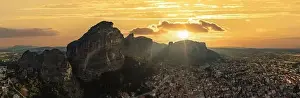 Meteora Greece panorama. Sunset and orange sky over Kalabaka town. Rock formations landscape, Europe travel destination