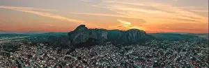 Thessaly Prints: Meteora Greece panorama. Sunset and orange sky over Kalabaka town