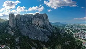 Thessaly Prints: Meteora Greece at sunrise, Blue sky with clouds over Monastery buildings on top of rocks and Kalambaka town and valley