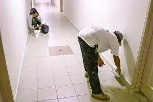 Immigrant Prints: Miami Beach Florida, Hispanic man installer installing new tile inside interior condominium condo residential apartment