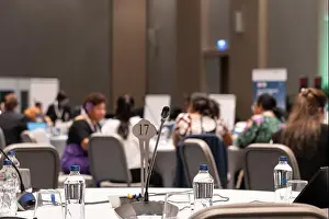 Listening Prints: A microphone and water bottles on the round table in the conference room