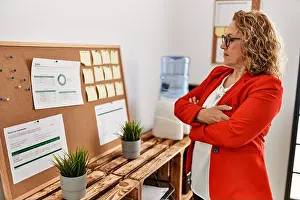 Concentrate Prints: Middle age caucasian businesswoman standing with arms crossed gesture at the office