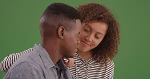 Intimate Prints: Millennial black man and woman look at each other lovingly on green screen