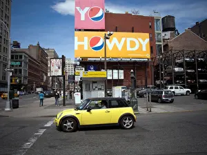 Thirst Prints: A Mini Cooper in front of an advertisement for Pepsi Cola in the New York neighborhood of NoHo