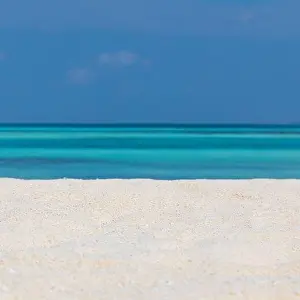 Minimal beach view, sea sand sky as relaxing summer scenery. Peaceful tropical beach landscape view. Clouds on blue sky, tranquil beach nature concept