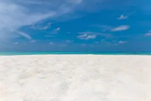 Minimal beach view, sea sand sky as relaxing summer scenery. Peaceful tropical beach landscape view. Clouds on blue sky, tranquil beach nature concept