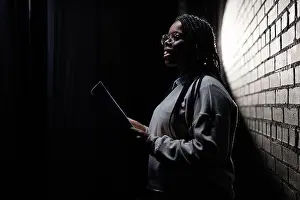 Black Man Prints: Minimal side view portrait of Black young woman rehearsing on stage in theater with low light copy space