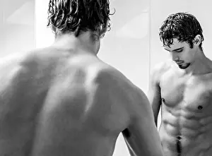 Shaving Prints: Mirror reflection of attractive shirtless man with abs and goatee