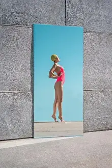 Mid Adults Prints: Mirror reflection of woman standing with hands on hips during sunny day