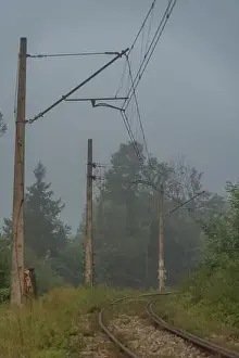 Silesia Prints: Mist morning with electric railway in Rajcza town with Sola river in middle of summer